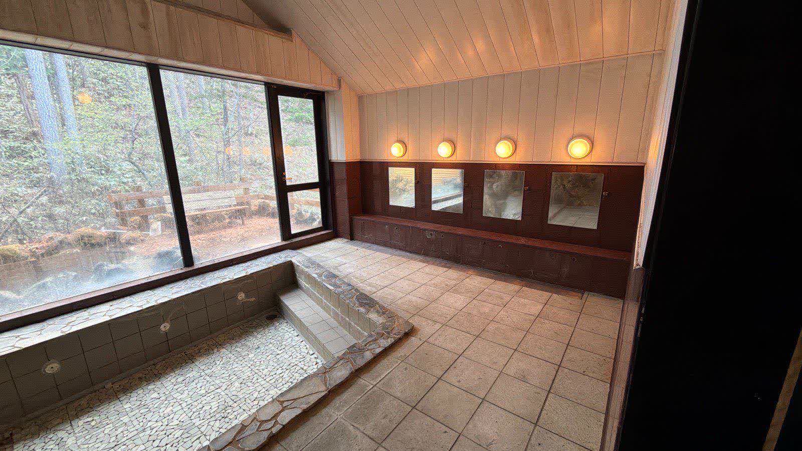 Forest-facing bath at Ryokan Mai in Norikura Kogen